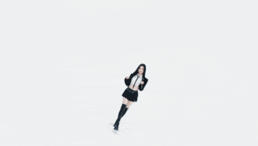 a group of women are dancing in a room with stairs