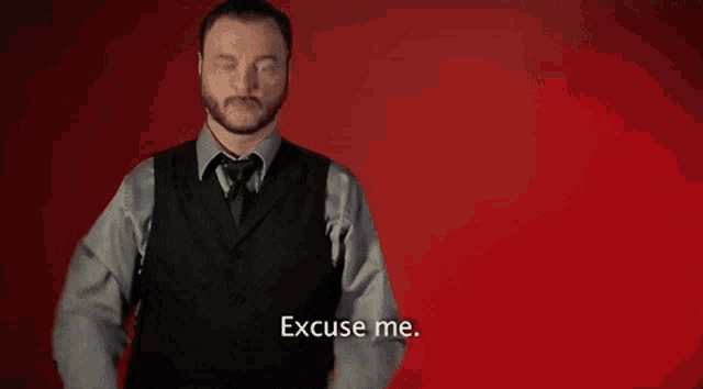 a man in a suit says excuse me
