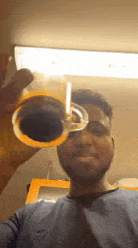 a man with a beard is holding a glass of beer