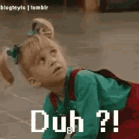 a little girl is laying on the floor with the words `` duh ? '' written on it .