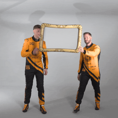 a man in a neon outfit holds up a gold frame