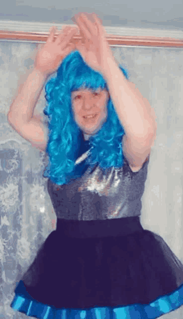 a woman wearing a blue wig and a black tutu