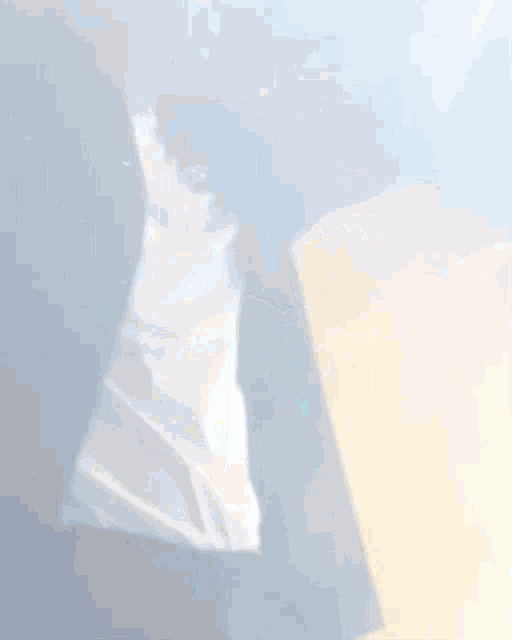 a blurred image of a person 's face with a white shirt