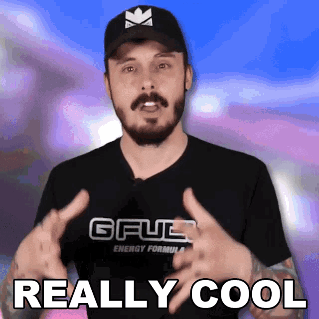 a man with a beard wearing a gfuel energy formula shirt says really cool