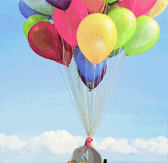 a bunch of colorful balloons are hanging from a string