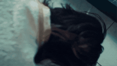 a person wearing headphones is laying on the floor