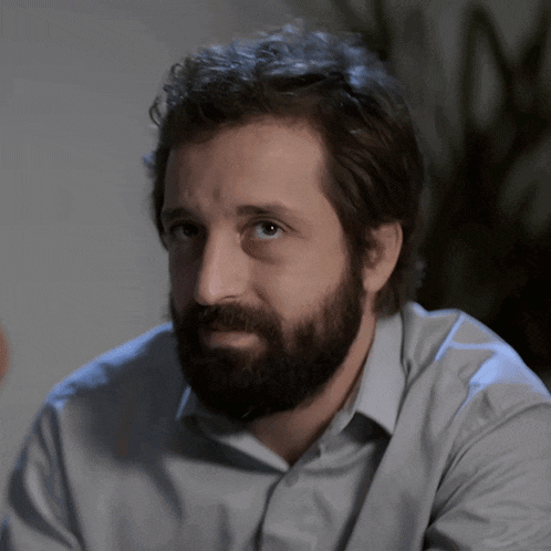 a man with a beard wearing a light blue shirt
