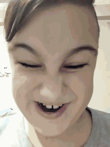 a woman is smiling with her eyes closed