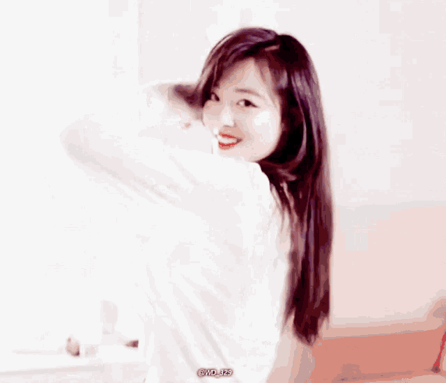 a woman with long hair is wearing a white shirt with the letters gvd on the bottom
