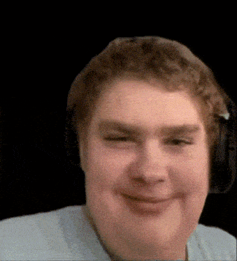 a man wearing headphones is smiling for the camera .
