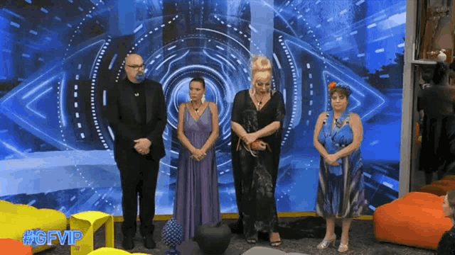 a group of people are standing in front of a screen that says #gfvip on it