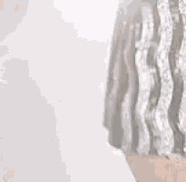 a close up of a statue of a man with a long beard .