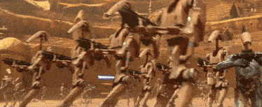 a group of robots are walking in a line with a sign that says " welcome " in the background
