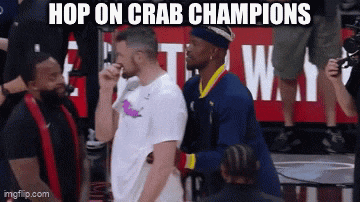 a group of men standing on a basketball court with the caption hop on crab champions .