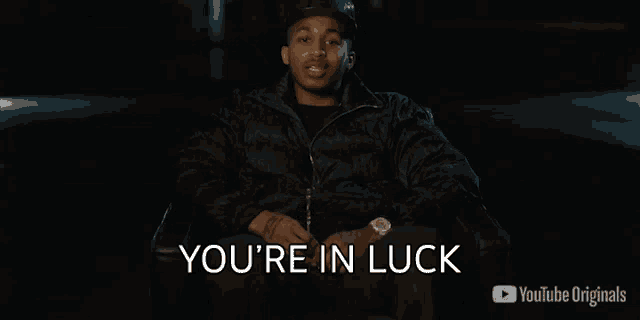 a man sitting in a chair with the words you 're in luck on the screen