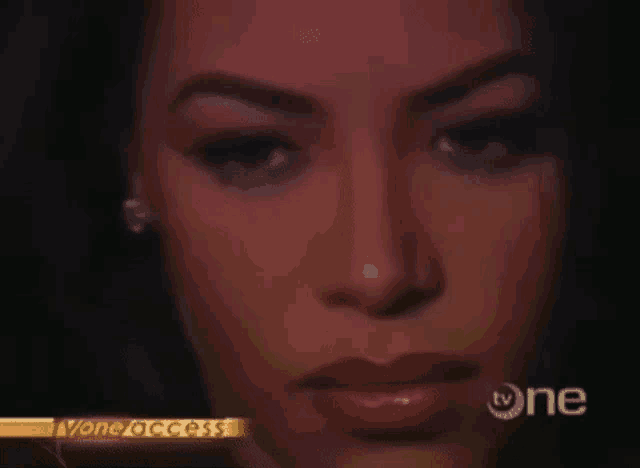 a close up of a woman 's face with red lipstick on a television screen .