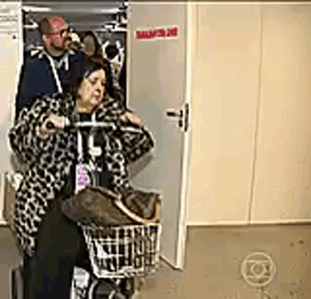 a man and a woman are standing next to each other in a closet .