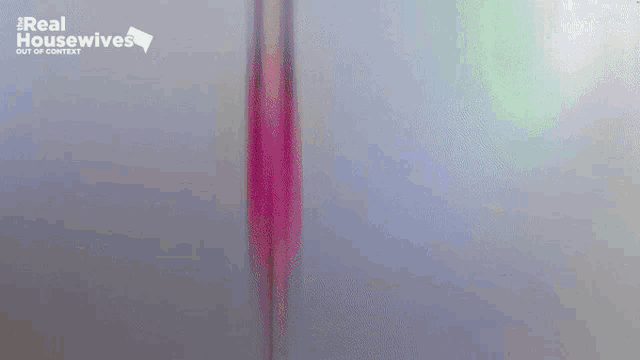 a blurry picture of a woman in a pink dress dancing