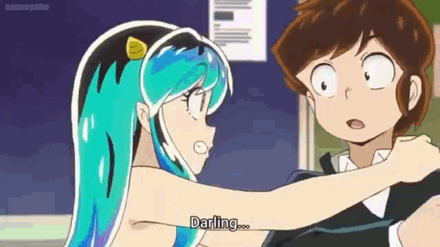 a boy and a girl are standing next to each other and the girl is talking to the boy .