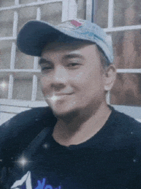 a man wearing a blue hat and a black shirt with the word reebok on it