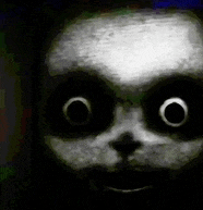 a close up of a panda bear 's face with big eyes in the dark .
