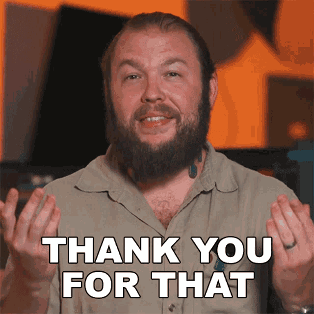 a man with a beard is giving a thank you for that sign