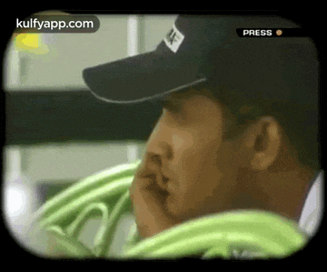 a man wearing a nike hat is looking at something
