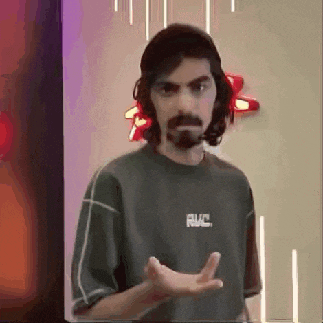 a man with long hair and a beard is wearing a t-shirt that says rvc .