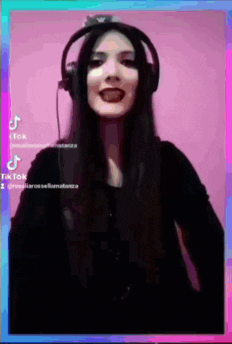 a woman wearing headphones is making a funny face with her tongue sticking out