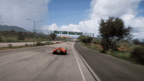 a car driving down a highway with a sign that says buena vista