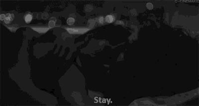 a black and white photo of a person laying on a bed with the words " stay " in the corner
