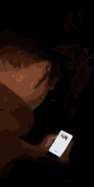 a close up of a person 's hand holding a cell phone