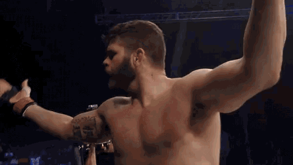 a man without a shirt has a tattoo on his arm that says ' i 'm a fighter '