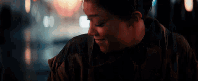 a close up of a woman 's face with a blurry background .