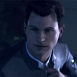 a man in a suit and tie is looking at the camera with a tear in his eye .