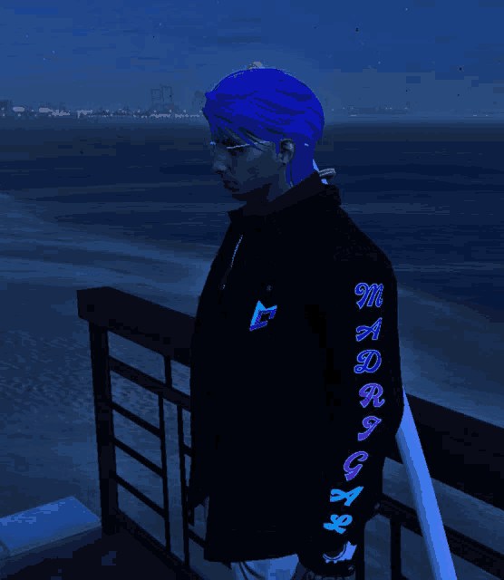 a man with blue hair and a black jacket that says m a drag on the sleeve