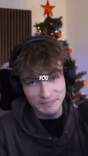 a man wearing headphones has the word you on his face