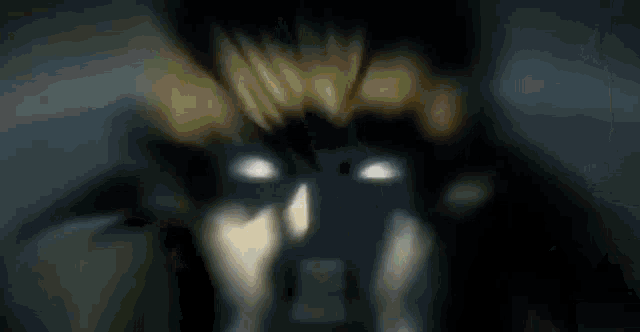 a close up of a person 's face with a glowing light coming out of their eyes .