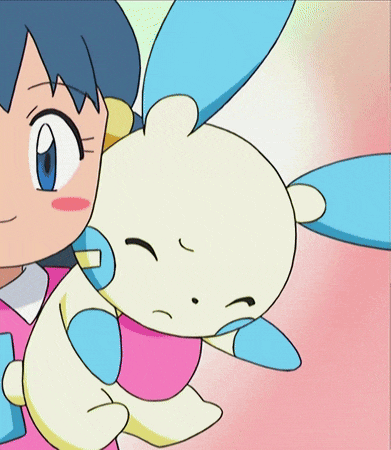 a girl in a pink shirt is holding a stuffed animal in her arms