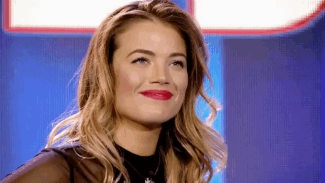 a close up of a woman 's face with red lipstick on her lips .