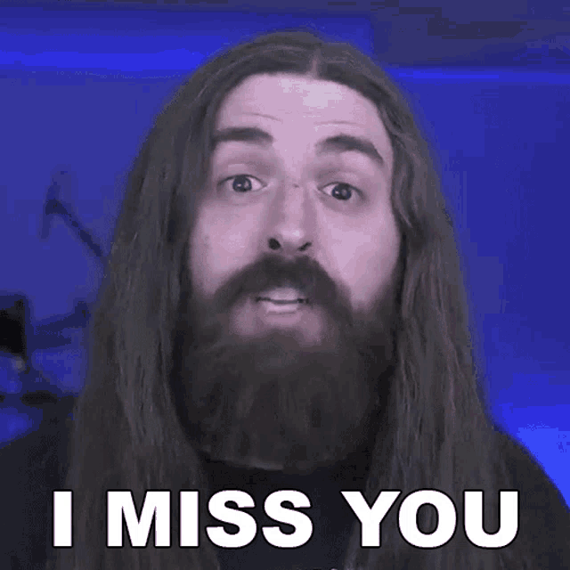 a man with long hair and a beard says i miss you .