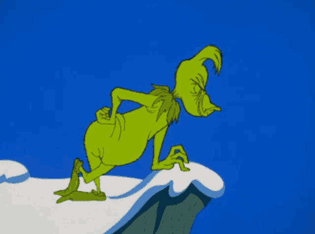 a cartoon of grinch standing on top of a snow covered cliff