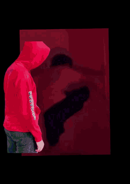 a person wearing a red hoodie with the word freedom on the sleeve
