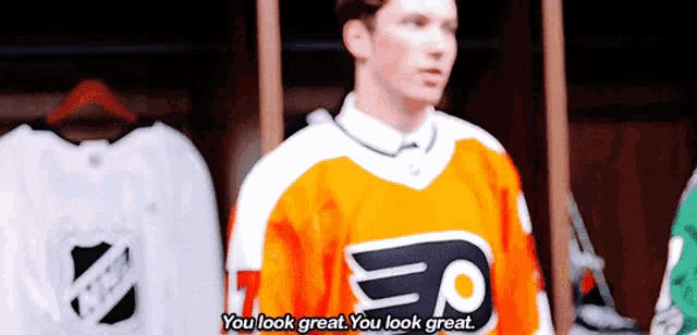 a man in an orange jersey with the letter p on it