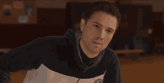 a man wearing a sweatshirt with a circle on it