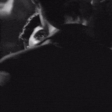 a black and white photo of a man and a woman dancing .