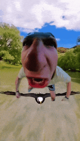 a man is flying through the air while holding a bird