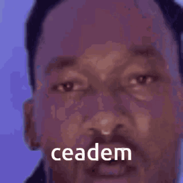 a close up of a man 's face with the words ceadem written on it .