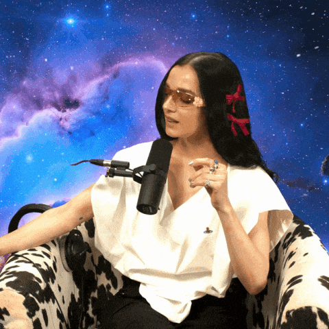 a woman sitting in a cow print chair with a microphone behind her