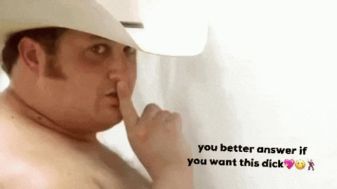 a shirtless man wearing a cowboy hat is holding his finger to his mouth .